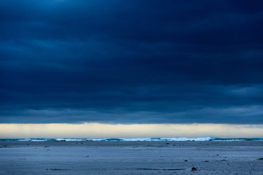 stormy clouds hover over lagoon and san beach, Hermanus, South Africa