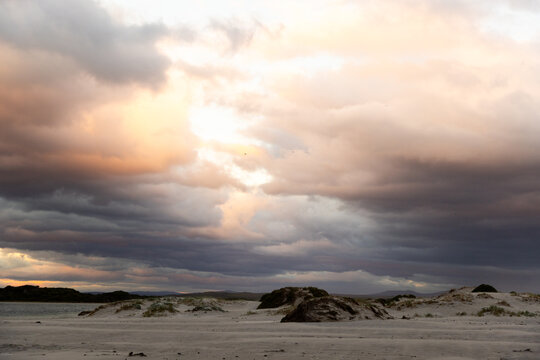 stormy clouds hover over lagoon and san beach, Hermanus, South Africa