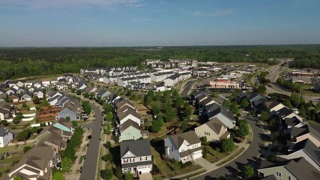 Aerial flyover shot of new housing development and retail shopping center in Wendell, North Carolina, near Raleigh