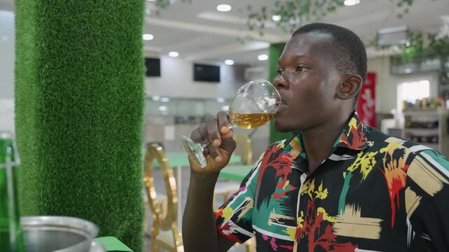 Man tastes wine. Gentleman samples his drink. Patron enthusiastically tastes wine in cozy cafe setting. Gentleman enthusiastically enjoys sampling glass of red wine in warm surroundings