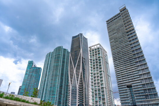 Modern high rise skyscrapers and luxury condominiums in downtown Miami. Architectural view of glass skyscrapers including One Thousand Museum under a cloudy sky in Miami.