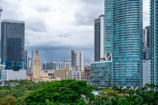 Freedom Tower and modern glass buildings in downtown Miami. Detailed architectural view of the historic Freedom Tower surrounded by modern high-rise apartments in Miami.