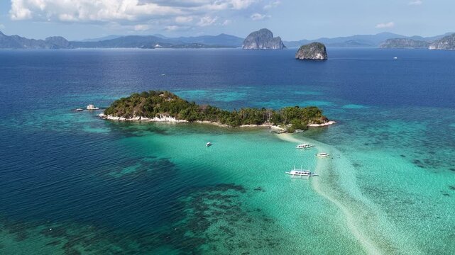 A sinuous sand bank stretches out from Snake Island in Bacuit Bay near El Nido, Philippines. This idyllic spot is a popular tourist destination and is a wonderful place to swim.