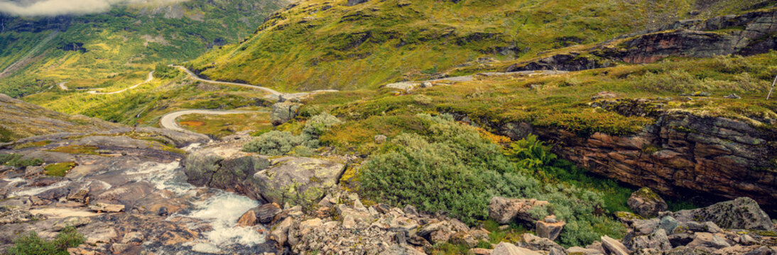 Autumn mountain landscape in Norway. Winding road in the mountains. Road 63 to Geiranger. View from Upper Blaafjeld Bridge