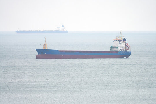 A tanker in an open roadstead at an anchorage in a sea bay.