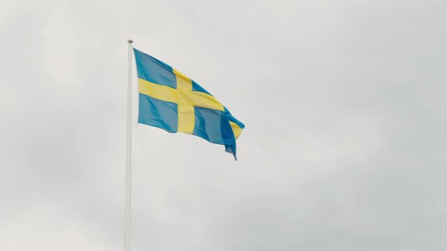 Waving Real Swedish Flag On Sky Background. Symbol Of Democracy,Traveling Sweden