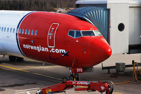 Helsinki, Finland, March 26th, 2025. Front view of Norwegian Air Shuttle ASA at the boarding bridge. Airplane parked at an airport gate at Helsinki Vantaa HEL terminal.