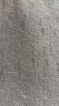 Close-up uniflex waterproofing membrane granular surface showing textured asphalt granules seams subtle weathering suggests