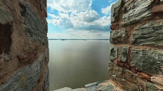 Ancient stone wall frames calm river below. Ram Fortress, Serbia