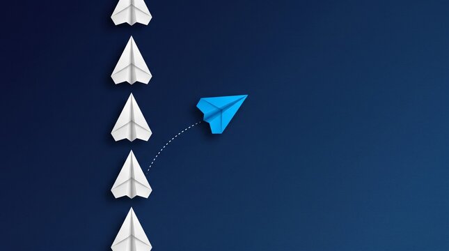 paper planes in a row on blue background and one paper glider going in different direction, breaking new ground and stepping out of the line concept