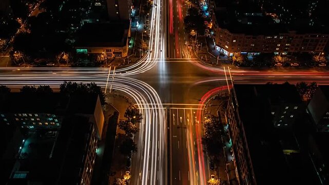 Aerial view of city intersection light trails at night