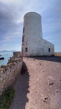 Historic Twr Mawr Lighthouse on the rocky shores of Ynys Llanddwyn, Anglesey, Wales, UK