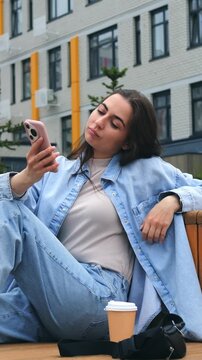 Young White Woman Leaning Back Bench Hair Flip Playful Expression Checking Phone For Selfies And Messages
