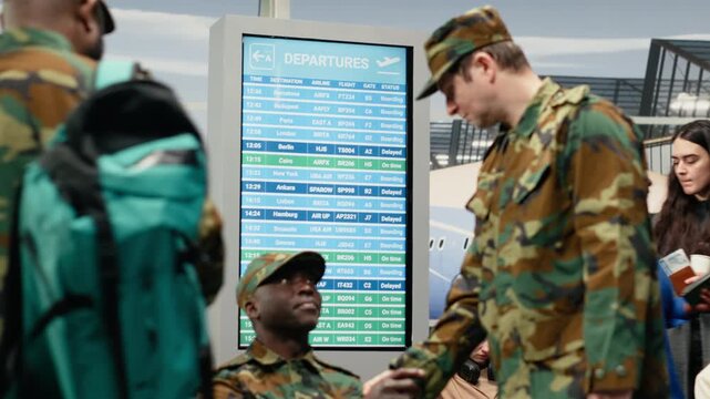 Talking, backpacks and military team troops in airport lounge waiting for plane departure. Discussing, camaraderie and multiethnic army squad in transportation hub, camera A
