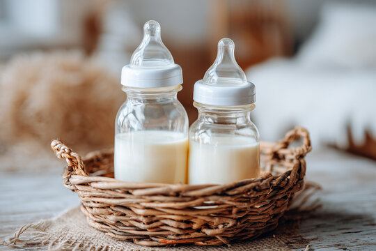Baby bottles with milk in basket.  Maternity and baby care concept.