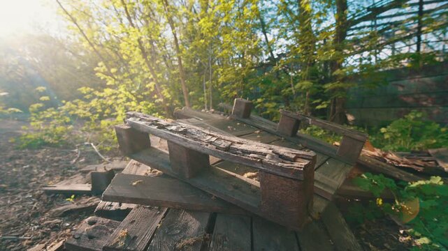 Abandoned Broken Wooden Pallets at Derelict Wasteland &mdash; Symbol of Supply Chain Crisis and Logistics Collapse | Ultra-Wide Angle Low Ground Sunset View