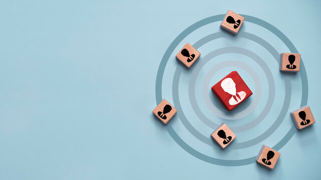 Target audience marketing concept with central customer icon on red block surrounded by user profiles for segmentation, targeting strategy, customer focus, data driven marketing and audience analysis