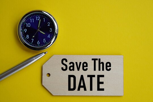 Management concept. The words save the date on wooden pieces and clock. Important date reminder. Time management. Effective use of time. Organized date notes.