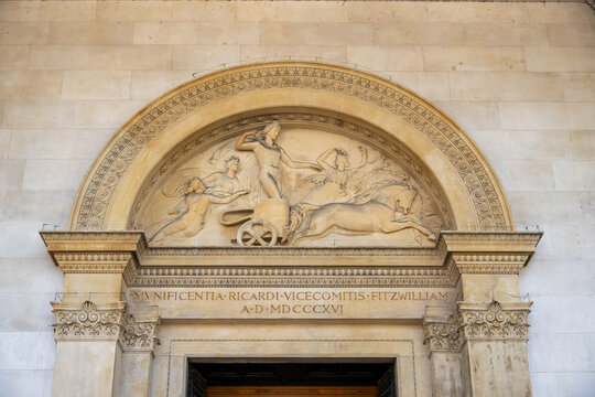 Neoclassical stone pediment relief above museum doorway, Cambridge
