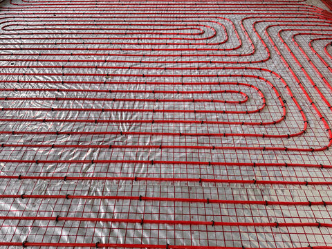 Installation of underfloor heating system in building, above view
