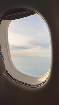 View from airplane window flying above clouds vertical background