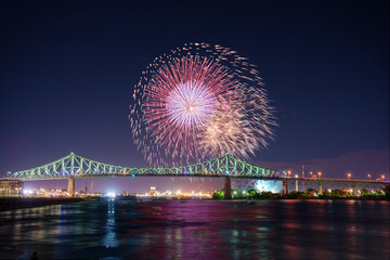 Naklejka premium Beautiful capture of the fireworks and The Jacques Cartier bridge in Montreal 