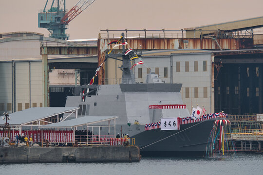 Japan Maritime Self-Defense Force patrol vessel Sakura (OPV-901), Sakura-class offshore patrol vessel at naming ceremony, confetti streamer burst over ship in dry dock, Kanagawa Prefecture, Japan