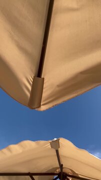 Luxury Beach Umbrellas Against Blue Sky Vertical Background
