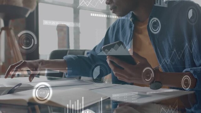 Analyst tapping phone at desk scanning charts while data overlays showing metrics for planning