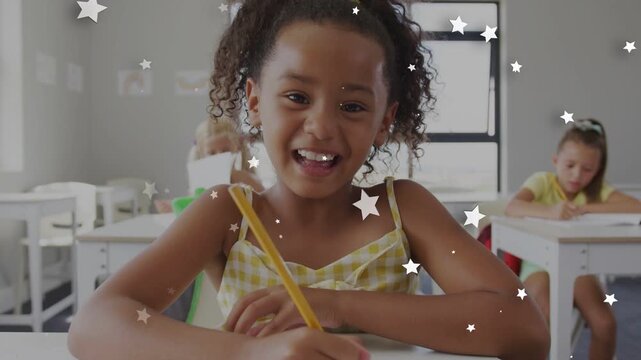Student writing with yellow pencil in classroom star overlay appearing and causing smiling laughing