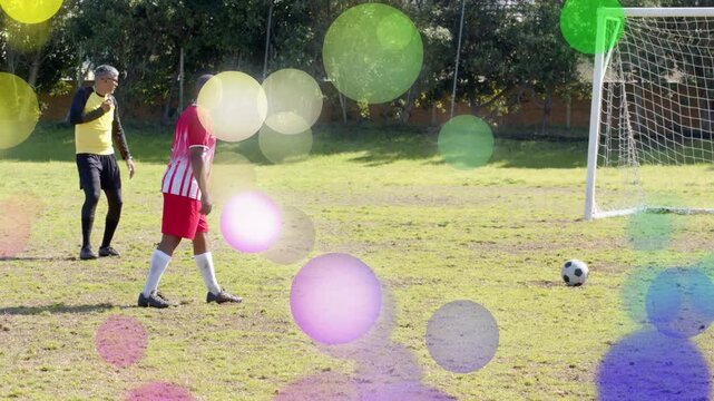 Sports ref stepping back kicker striking ball trying to score at goal keeper diving wall watching