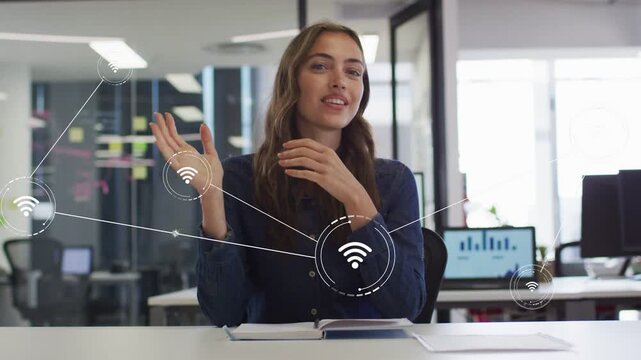 Woman speaking to camera at desk, causing Wi-Fi icons and lines expanding, showing network status