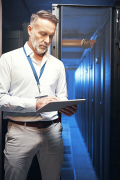 Engineer, man and typing on tablet in server room for maintenance, diagnostics and IT solution. Technician, mature person and tech in data center for system backup, troubleshooting and cybersecurity