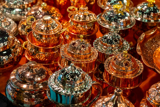 Metal coffee cezve with decorative oriental pattern on the shop window. Household items copper items for sale. Cupric coffeepots at the bazaar in Antalya Turkey. Turkish coffee pots. Metal coffee cezv