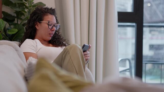 Woman's emotional shift from joy to concern while using smartphone