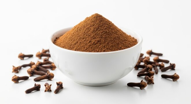Aromatic ground cloves in white ceramic bowl, organic clove powder and whole dried spice buds, culinary seasoning for baking and cooking on white background