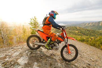 Fototapeta premium Professional motorcyclist rides in the mountains in autumn