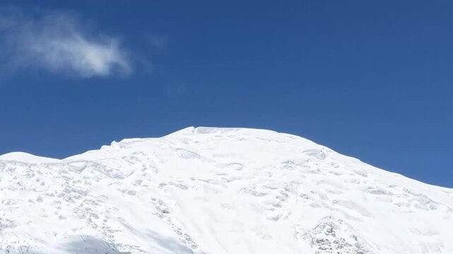 Majestic snow-capped Himalayan mountain range under moving clouds on the high altitude Tibetan Plateau, China.