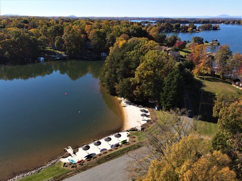 Aerial View of Private Sandy Beach and Umbrellas on Smith Mountain Lake Virginia in Fall
