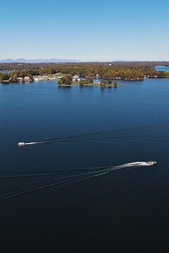 Aerial View of Two Speedboats Leaving Wake Trails on Smith Mountain Lake Virginia in Autumn