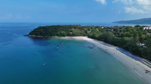 Aerial View of Serene Tropical Beach with Clear Blue Water and Lush Greenery Under Bright Sky and Distant Horizon