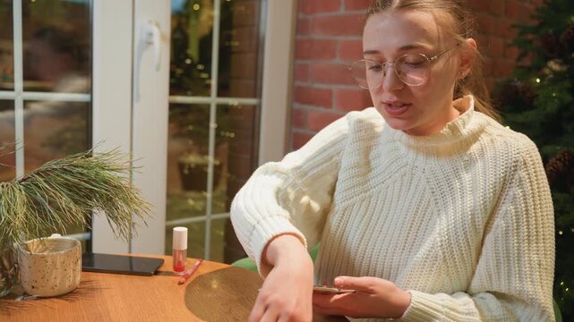 Brunch cafe tasting with white female critic sampling jam from spoon at wooden table by window, brick backdrop, warm string lights, potted plant, pastry nearby, focused expression, culinary review