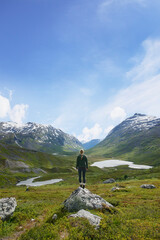 Fototapeta premium Back, hiking and woman in nature with mountain view, adventure and exploration with space in winter. Trekking, countryside and person outdoor for travel, vacation or sightseeing on holiday at valley