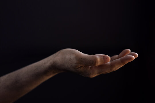 Dirty hand in begging gesture, Poverty and humanitarian crisis