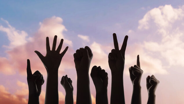Group of raised hands protest gesture against sky, freedom expression, social movement
