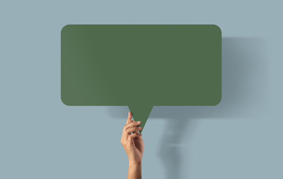 Hand holding blank speech bubble, communication and conversation concept