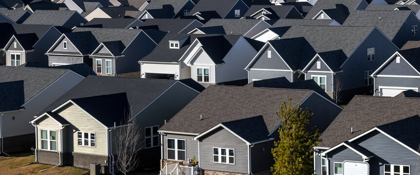 Crowded suburban neighborhood houses with rooftops creating patterns