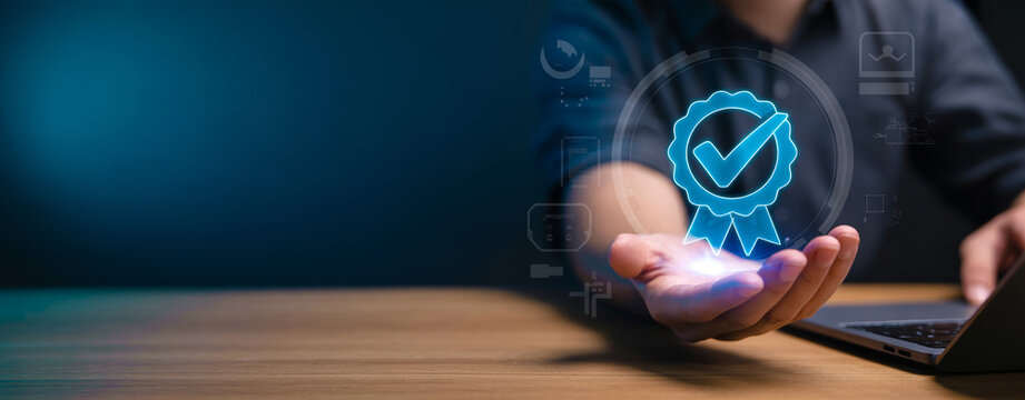 Man holding hand with glowing blue quality assurance badge icon, concept of certified and guaranteed services.