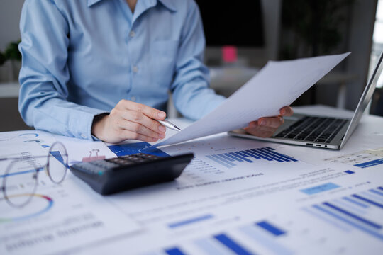 Business person analyzing financial documents and data on office desk