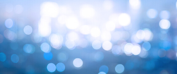 Fototapeta premium A soft and dreamy abstract background featuring blurred blue lights creating a tranquil atmosphere, perfect for use in various design projects.